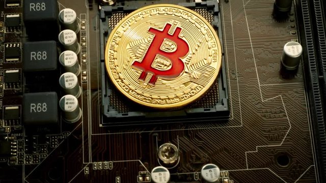 Gold Bit Coin BTC coins on the motherboard. Bitcoin is a worldwide cryptocurrency and digital payment system called the first decentralized digital currency.