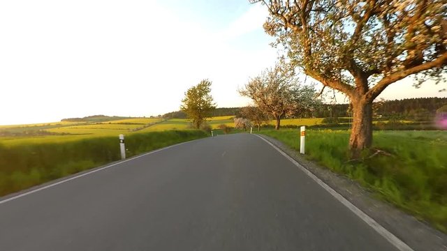Car driving in spring time in rural countryside