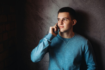 Man with phone in a cafe stand opposite the window
