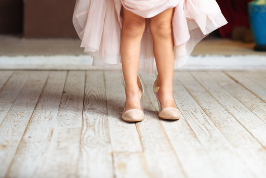 A little girl wearing mums shoes
