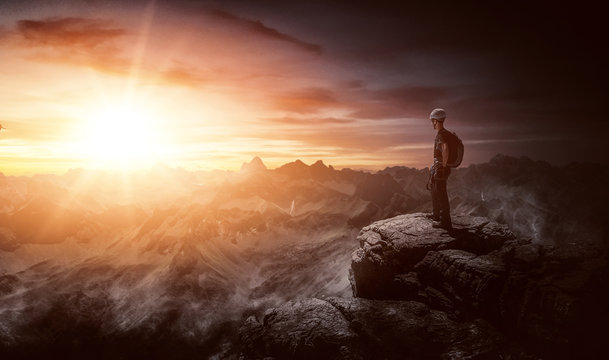 Male backpacker standing on a mountain summit