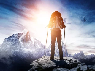 Fototapeten Backpacker or hiker in the Alps in winter © XtravaganT