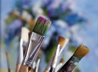 Fototapeta premium Artistic brushes on the background of a painting with a paint