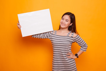 Naklejka na ściany i meble Young Asian woman with white blank sign.