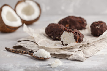 Raw homemade vegan chocolate coconut dessert bounty, white background. Healthy vegan food concept.