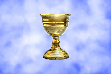 Old chalice on clouds background