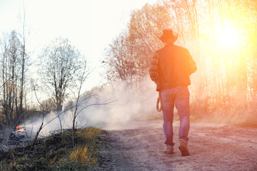 Fototapeta premium A man is wearing a cowboy hat and a loso in the field. American 