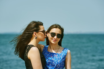 Young women relax in the summer by the sea