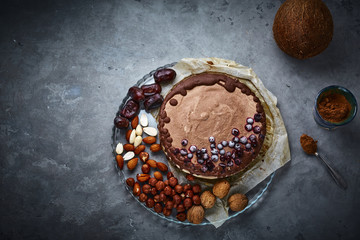 Chocolate vegan cake with different nuts, dates and carob