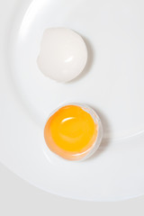 close-up of chicken egg on a white plate.