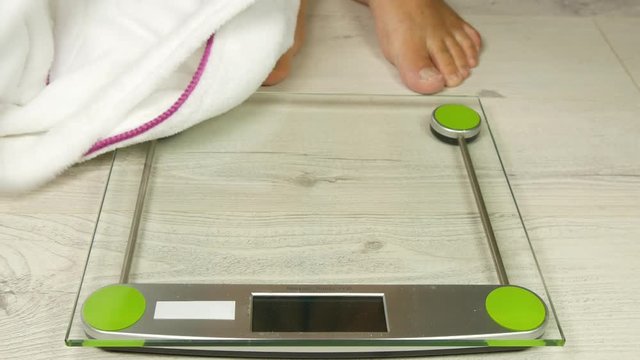 Man Checking His Weight Verify Obesity with a Digital Electronic Scale