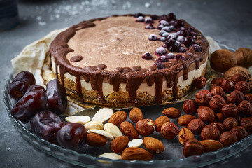 Chocolate vegan cake with different nuts, dates and carob