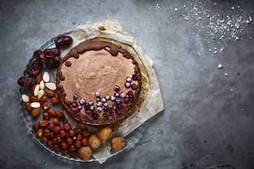 Chocolate vegan cake with different nuts, dates and carob