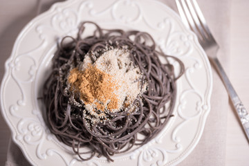 Organic healthy bio low carb bean noodles with white poppy seeds, mandarines and coconut sugar on vintage plate