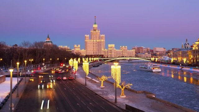 Moscow, Russia. Sunset over famous landmarks - Kotelnicheskaya Embankment Building - Stalinist skyscraper. Time-lapse with car traffic in the capital of Russia. Bridges over Moscow river, zoom out
