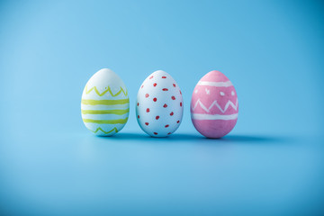 Colorful Easter eggs hand painted on a blue background. Holiday spring card