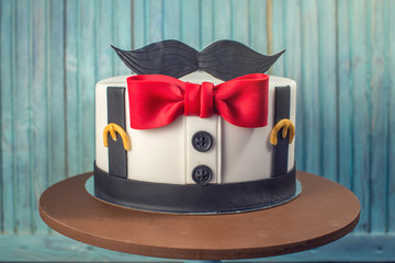 Beautiful cake for men, decorated in the form of a suit with a bow tie. Concept of the desserts for...