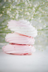 Raspberry meringue on white concrete desk. Space for text.