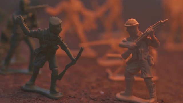 toy model soldier in the fire. The concept of the death of war. slow motion