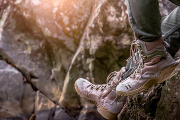 Close Up Shoes of Tourist Sitting On The Rocks Near River Side. Hiking Destination Experience Lifestyle Concept