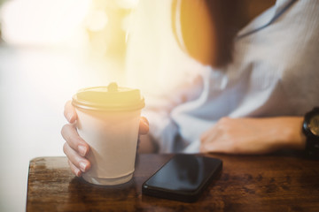 Hot drink in paper cup in hands close up