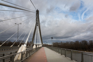 Swietokrzyski bridge over the Vistula river at cloudy day in Warsaw, Poland