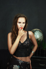 Beautiful model is deeply emotionally posing in a dark studio