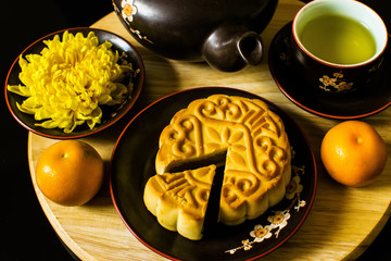 Flat lay modern stylised mid autumn festival food on black background