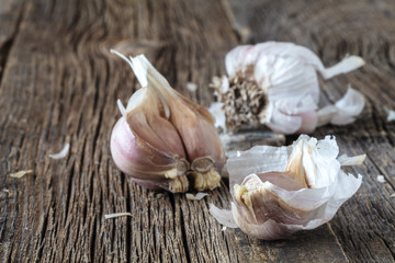 Head of dry garlic on rustic table, close up