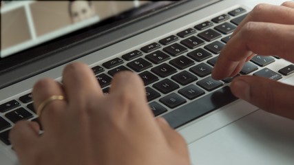 Fototapeta na wymiar closeup of man's hand and notebook keyboard working with notebook