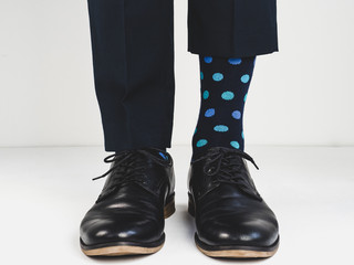 Stylish, black shoes and bright socks on a white background. Style, fashion, beauty