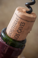 closeup of corks wine on wooden background with french text "mis en bouteille dans nos caves" traduction of bottled in our cellars © pixarno