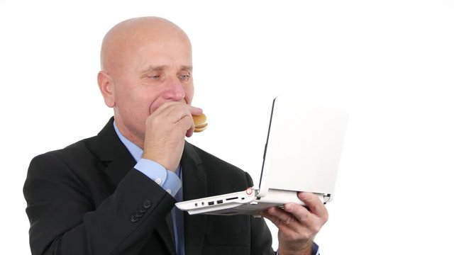 Hungry Businessperson Use Laptop and Eat a Tasty Sandwich in Lunch Break