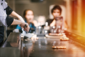 Hand of man take cooking of meat with vegetable grill, Chef cooking wagyu beef in Japanese teppanyaki restaurant