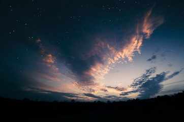 Naklejka premium twilight sky with vivid clouds and stars