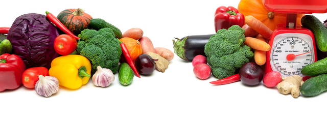 vegetables and a kitchen scale on a white background
