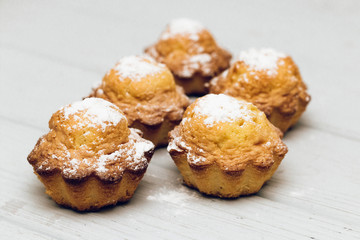 Delicious sweet cupcakes on white wooden table, delicious homemade dessert