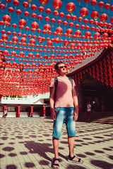 Tourist visit Thean Hou temple, Kuala Lumpur attraction. Travel to Malaysia. Architecture background. Religious concept. City tour. Culture trip. Tourism industry. Man stand under chinese red lanterns