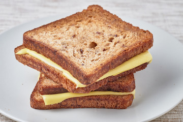 Grilled sandwich with cheese on a plate.