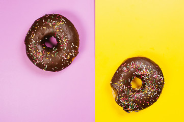 Composed glazed doughnuts on colorful surface