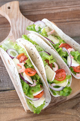 Tacos with shrimps, brie and fresh vegetables