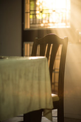Wood dinner chair in house and sunlight on sunset.