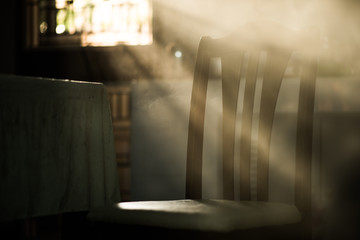 Wood dinner chair in house and sunlight on sunset.