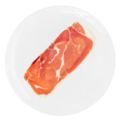 Single slice of raw prosciutto crudo or jamon on white plate isolated