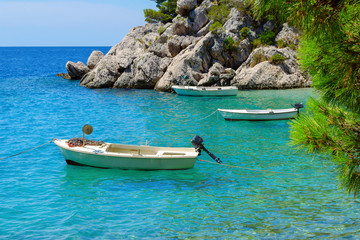 Fototapeta na wymiar Brela, Croatia with adriatic sea and boats in summer. Dalmatia, Makarska Riviera