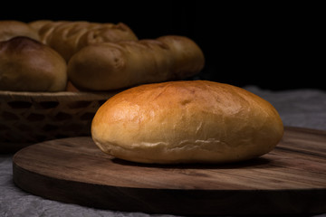 Fresh homemade burger bread buns on dark wood background