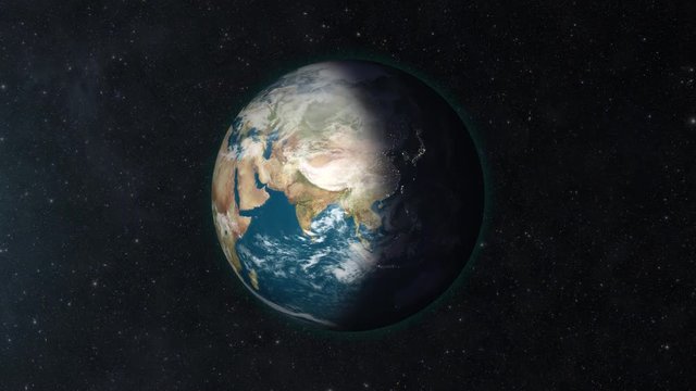 Slowly zooming into the Earth in space. The day/night terminator is visible as the Earth rotates.  