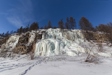 Fototapeta na wymiar Cliff with frozen waterfalls. Frontal view