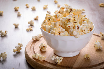 Salt popcorn on the wooden table, selective focus