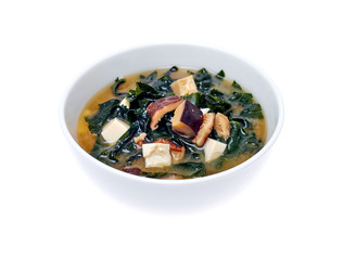 Bowl of thick mushroom soup over white background